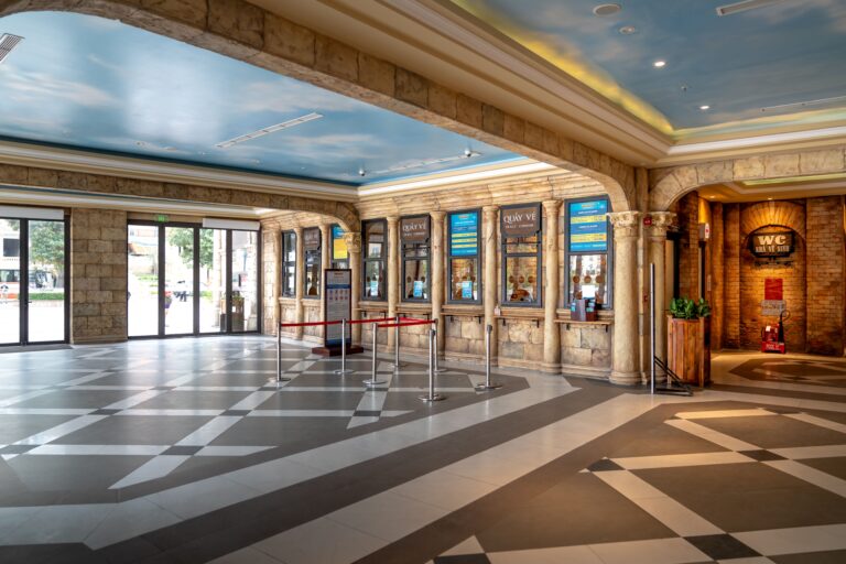 OUR STORY Spacious ticket booth area with elegant design and sky mural ceiling, perfect for luxury venues.