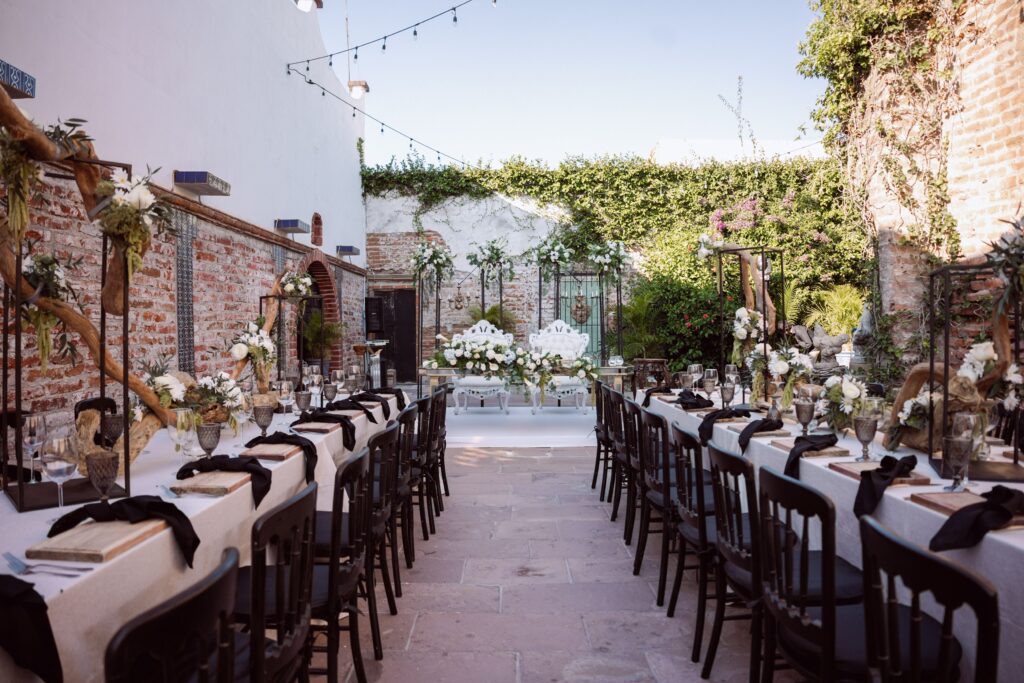 Beautifully decorated outdoor wedding table setting with floral arrangements and rustic charm.